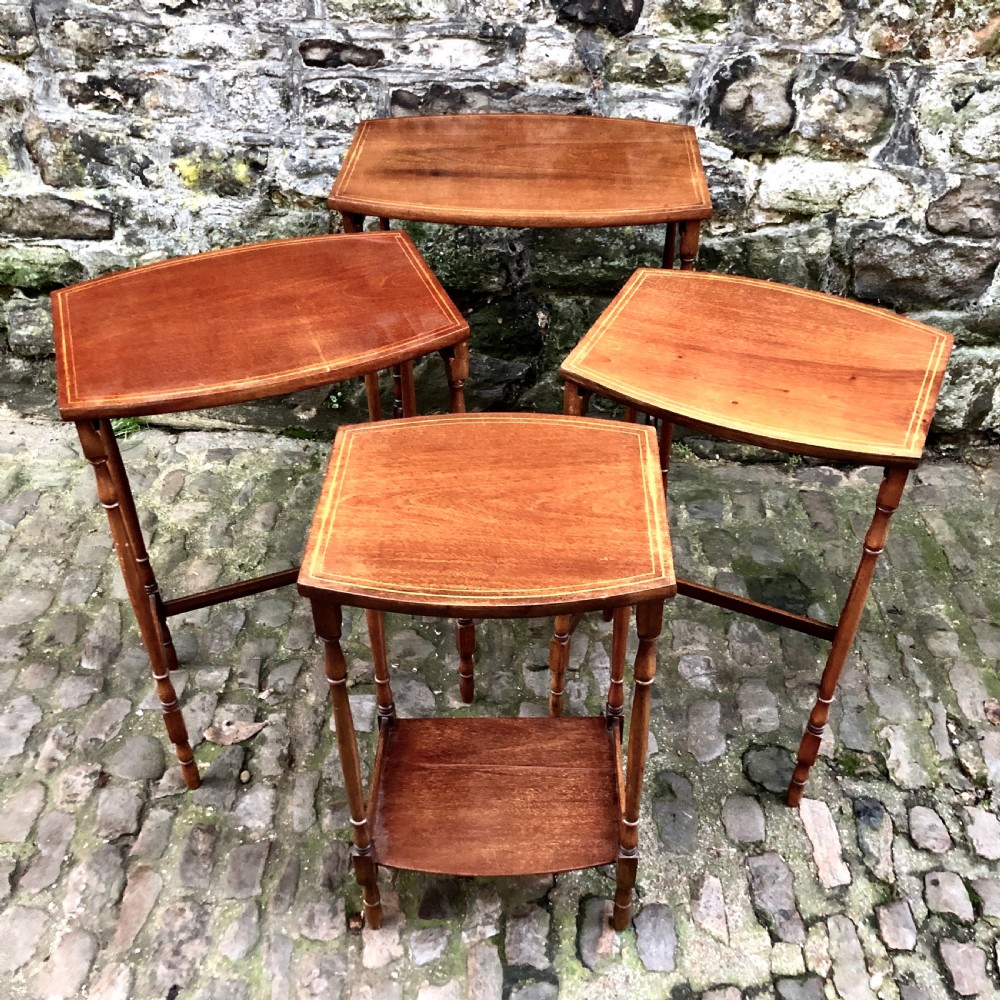 An Edwardian nest of four mahogany side tables  View II