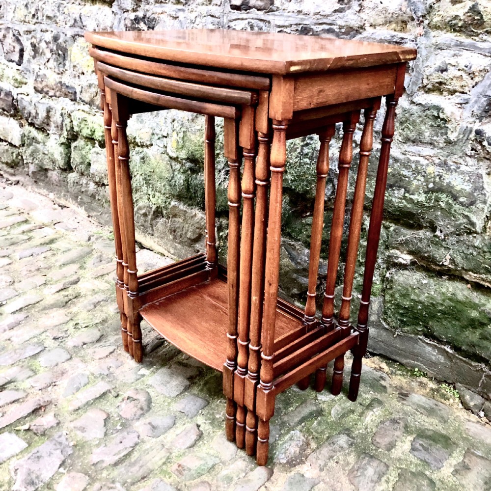 An Edwardian nest of four mahogany side tables  View V