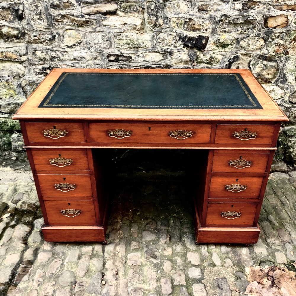 A small Edwardian walnut pedestal desk