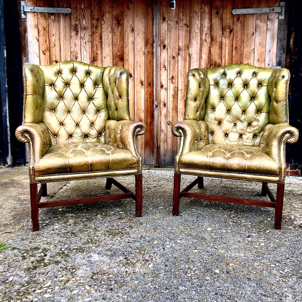 A pair of leather wing armchairs 