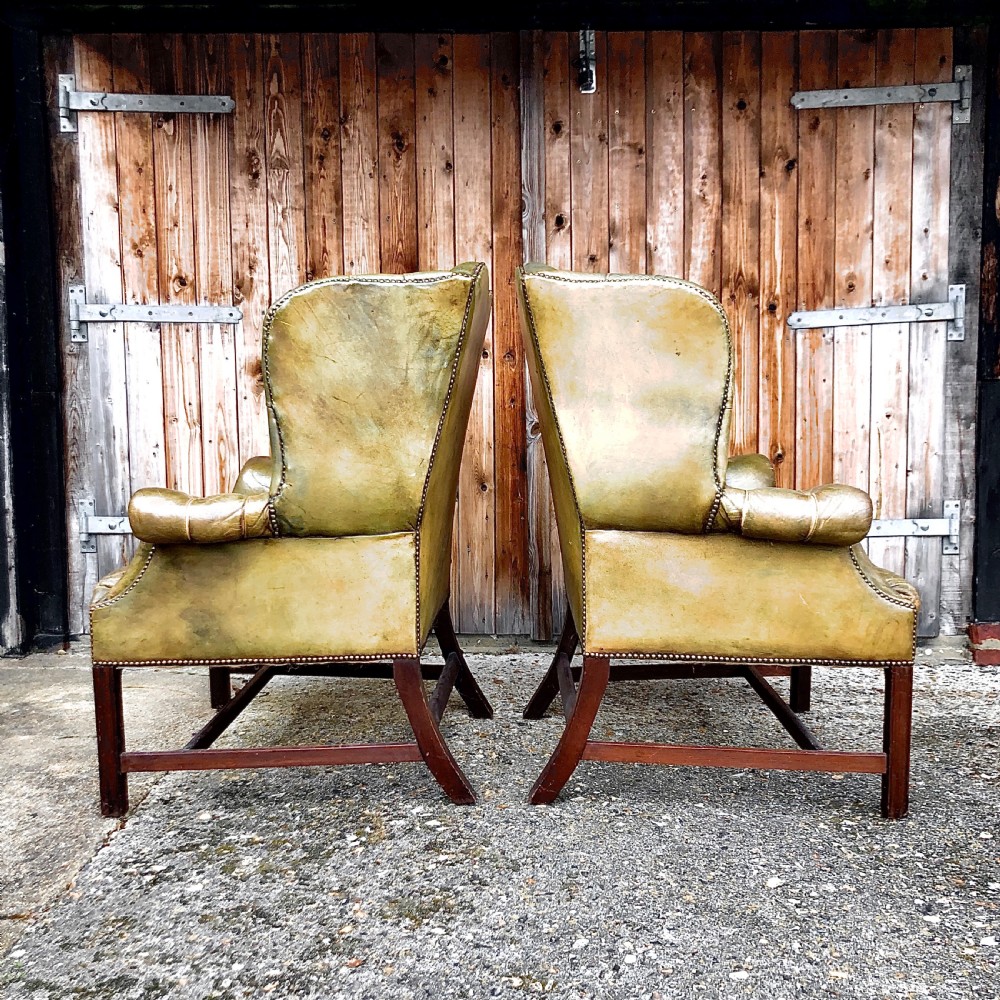 A pair of leather wing armchairs  View II
