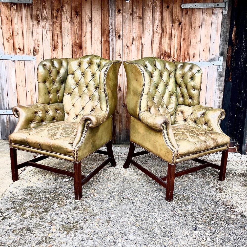 A pair of leather wing armchairs  View V