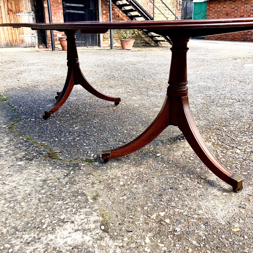 An Edwardian mahogany twin pedestal dining table  View II