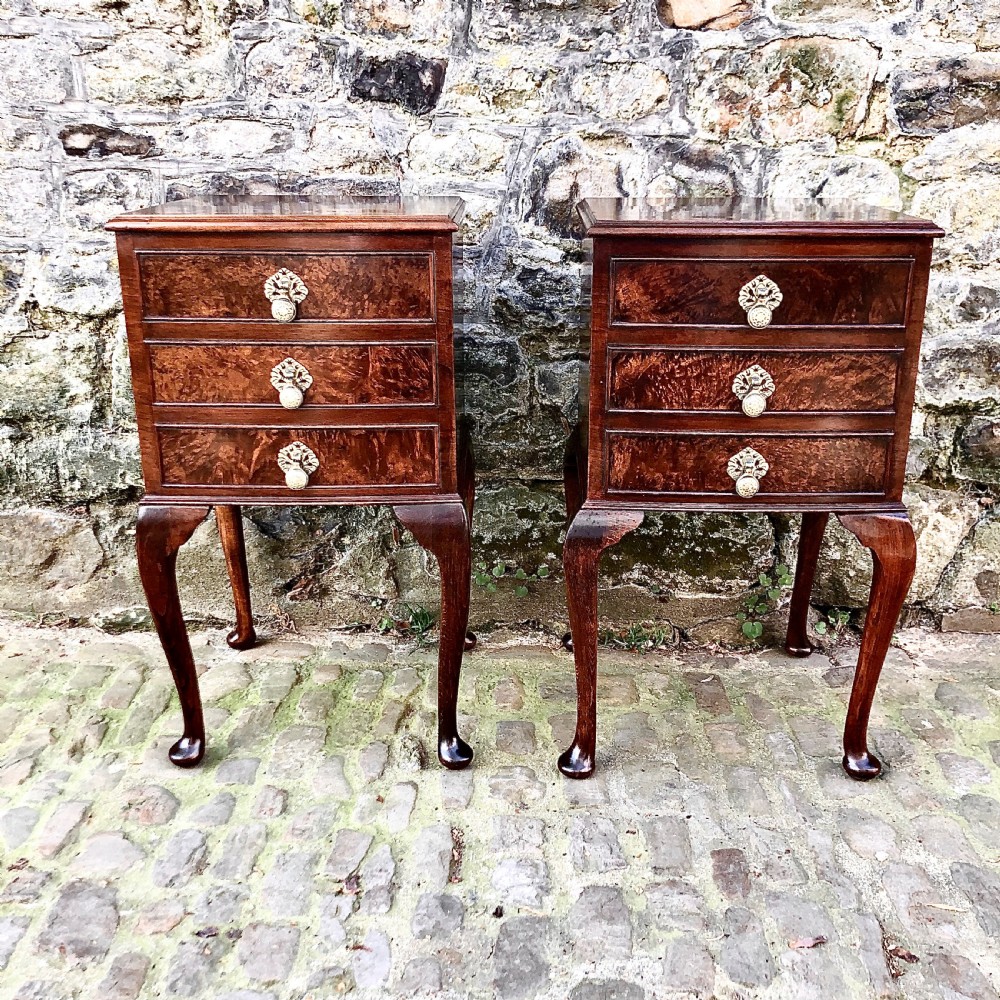 A pair of early 20th century walnut bedside tables 
