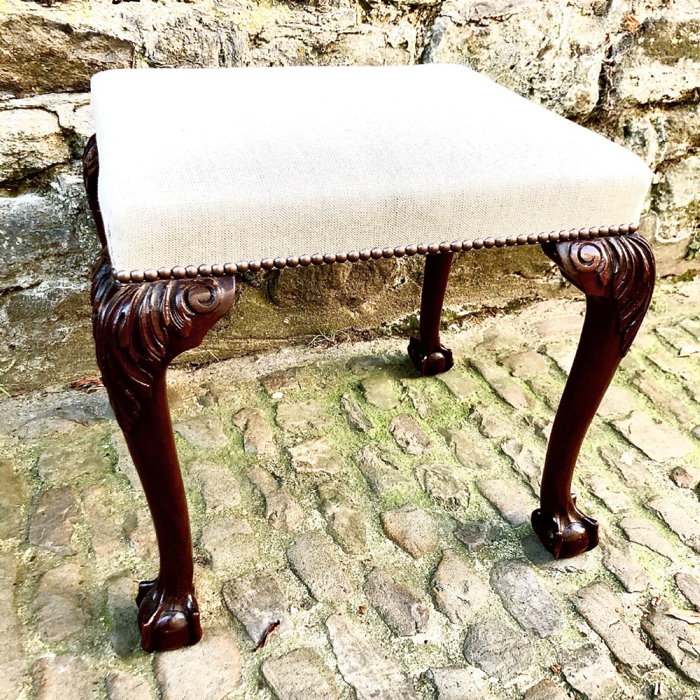A late 19th century mahogany stool in the George II style