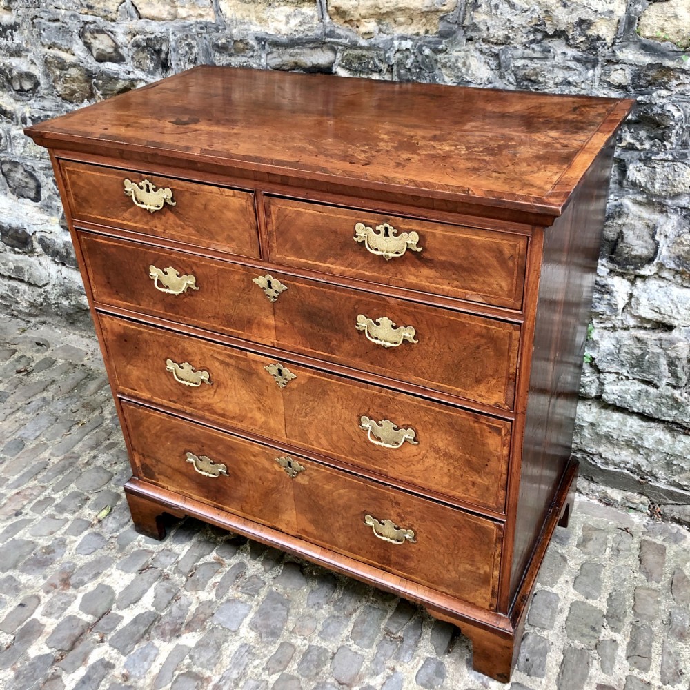 A George II walnut chest of drawers  View II