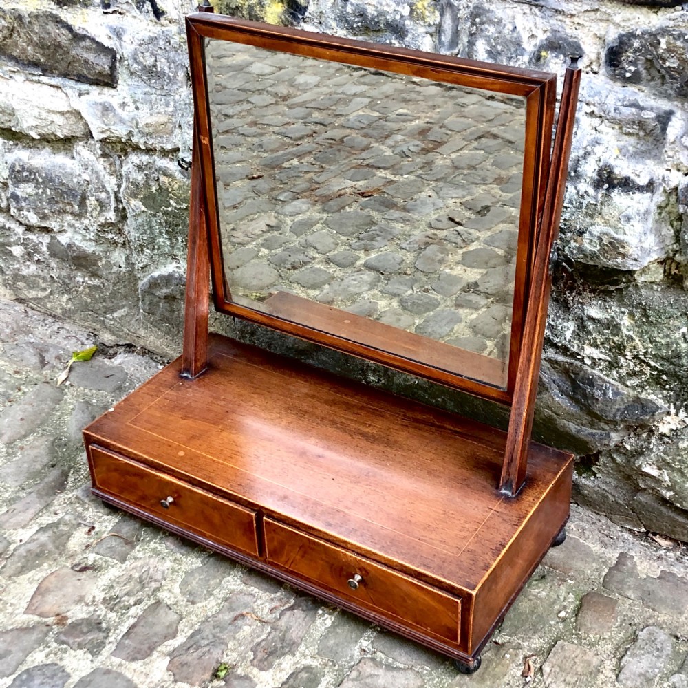 A George III mahogany dressing table mirror with a rectangular swivel glass frame set above a two-drawer base. View III