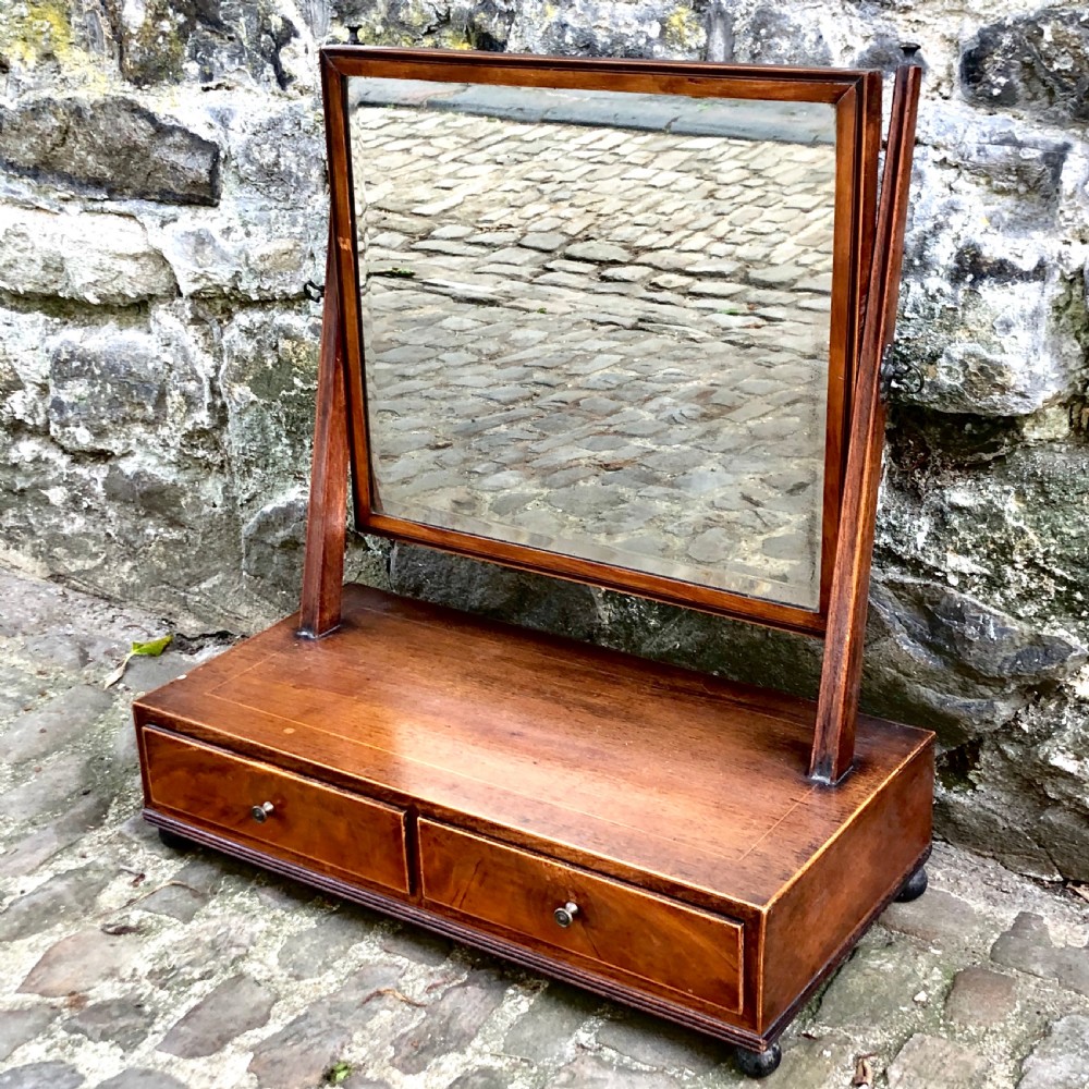 A George III mahogany dressing table mirror with a rectangular swivel glass frame set above a two-drawer base. View IV