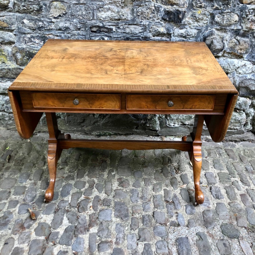An early 20th century walnut sofa table by Heals
