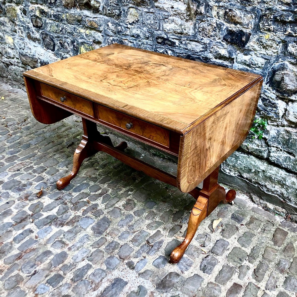 An early 20th century walnut sofa table by Heals View II