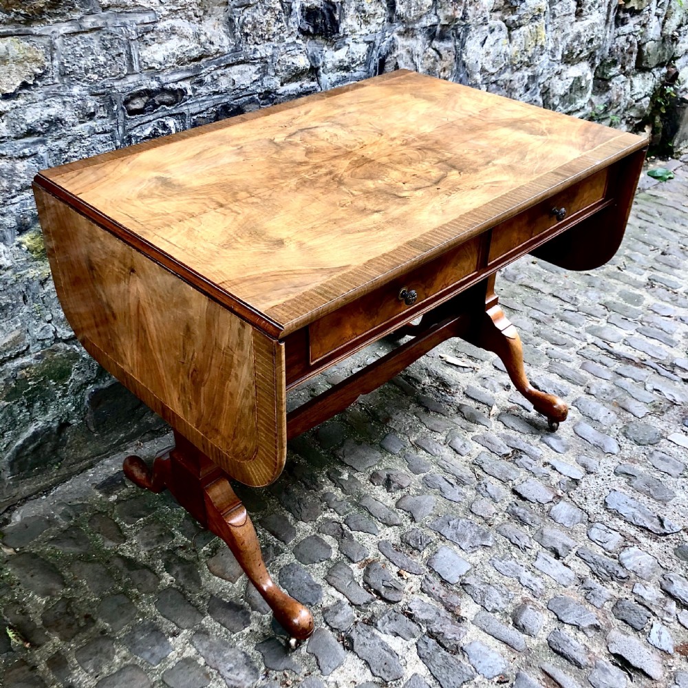 An early 20th century walnut sofa table by Heals View III
