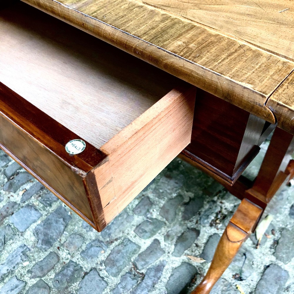 An early 20th century walnut sofa table by Heals View VI