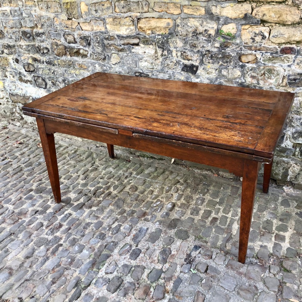 A French 19th century extending farmhouse kitchen table 