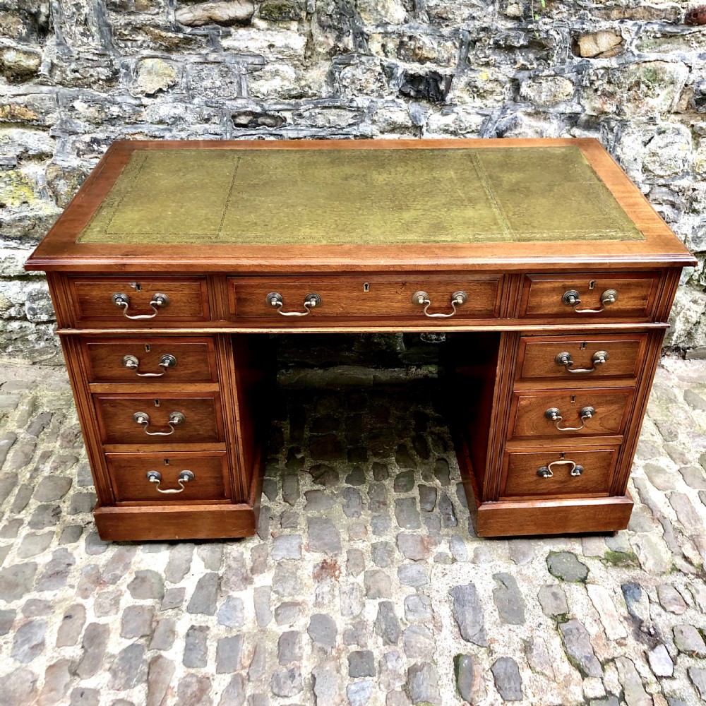 An Edwardian walnut pedestal desk 