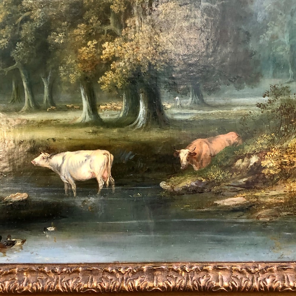 A late 18th-century oil painting on canvas depicting a rural landscape with cattle standing in a stream, surrounded by mature trees, housed in a moulded giltwood frame. View II