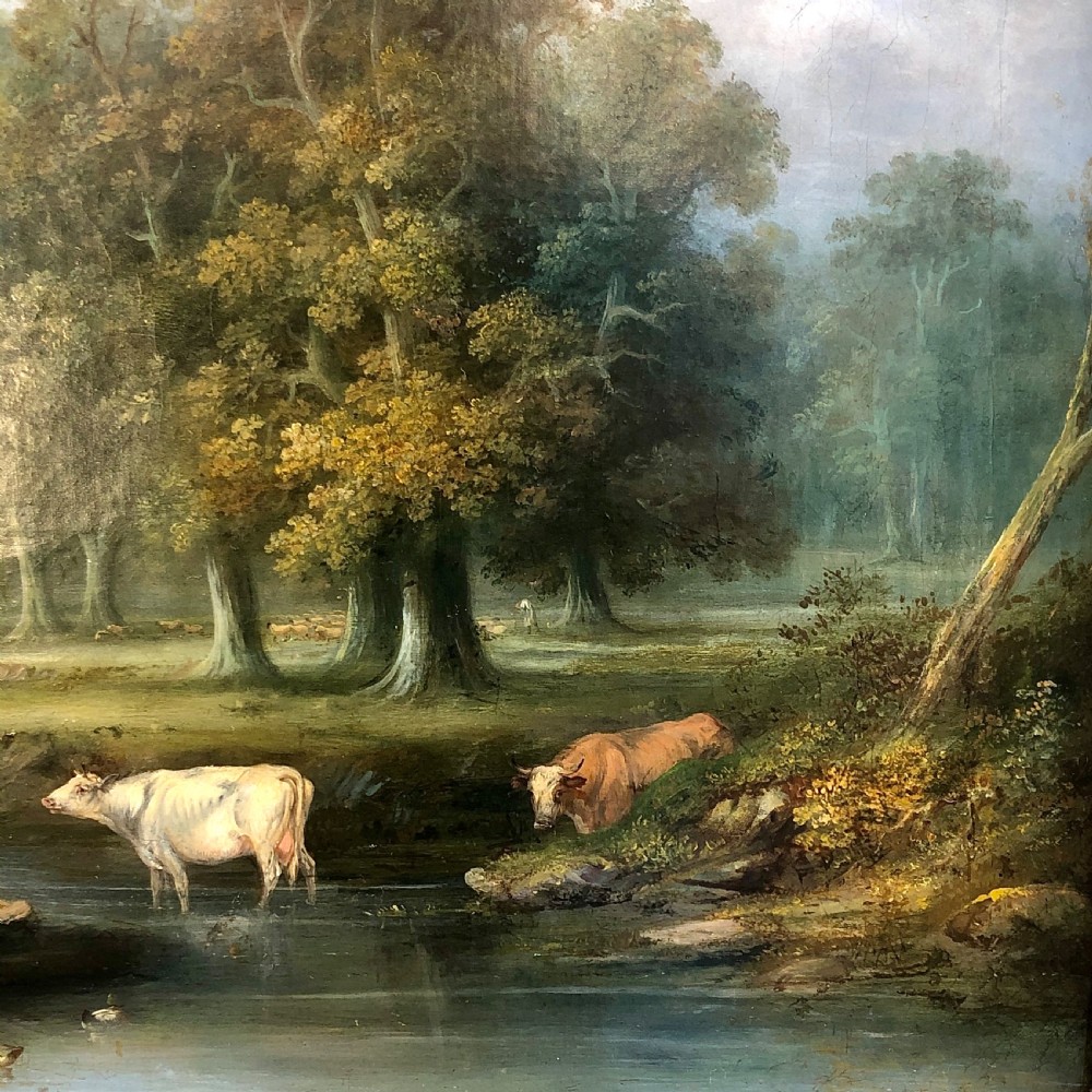A late 18th-century oil painting on canvas depicting a rural landscape with cattle standing in a stream, surrounded by mature trees, housed in a moulded giltwood frame. View V