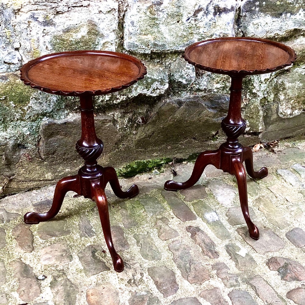 A pair of small Edwardian mahogany tripod wine tables  View II
