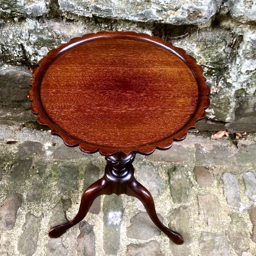 A pair of small Edwardian mahogany tripod wine tables  View VI