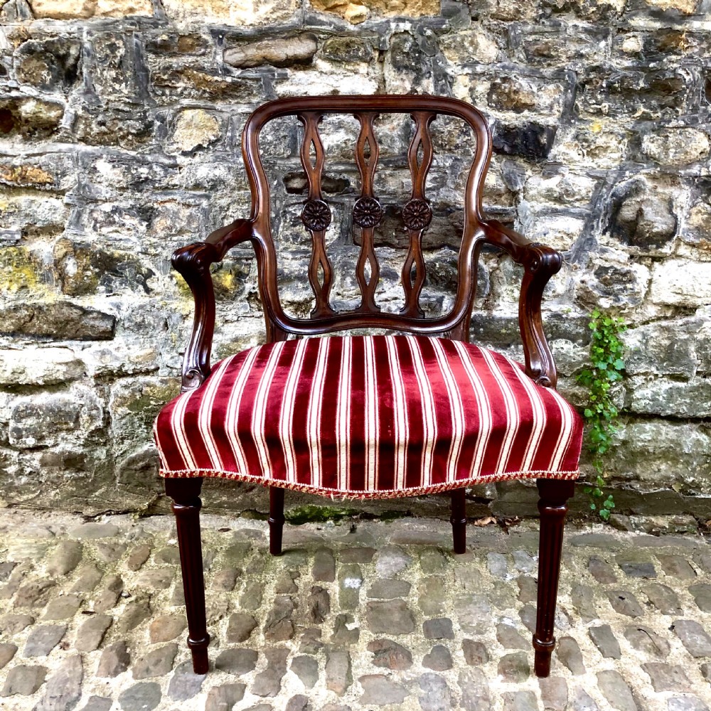 An Edwardian mahogany elbow or desk chair 