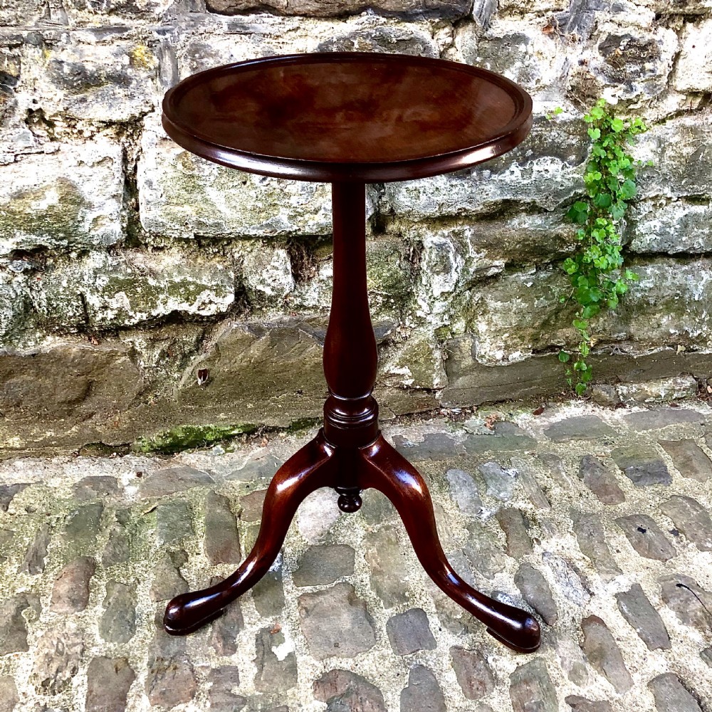 A mahogany tripod wine table in the George III style