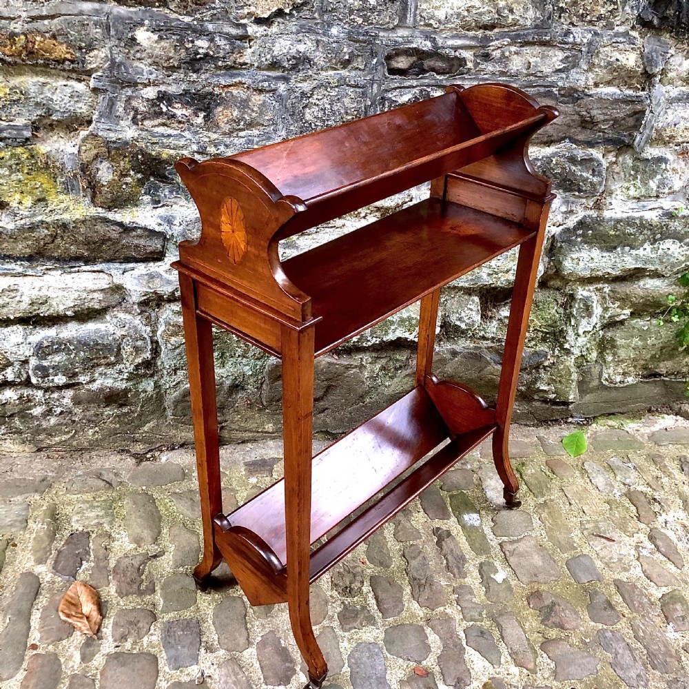 An Edwardian mahogany two tier book trough 