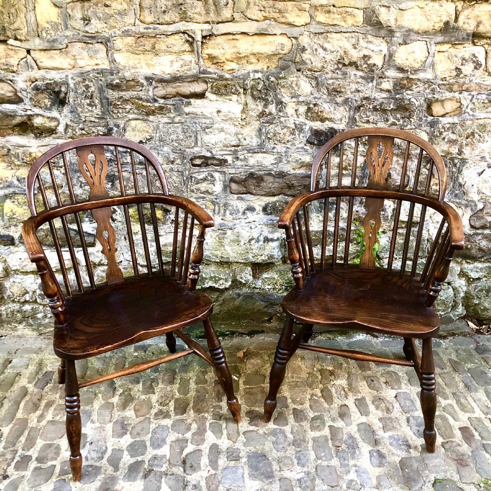 A pair of early 20th century Windsor elbow chairs 