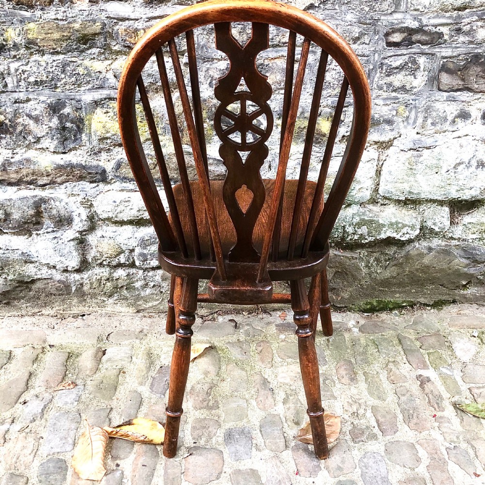 A set of six late 19th century Windsor wheelback chairs View X