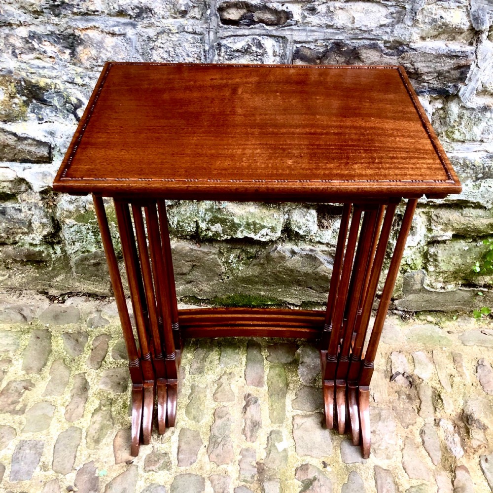An Edwardian mahogany nest of four tables  View II