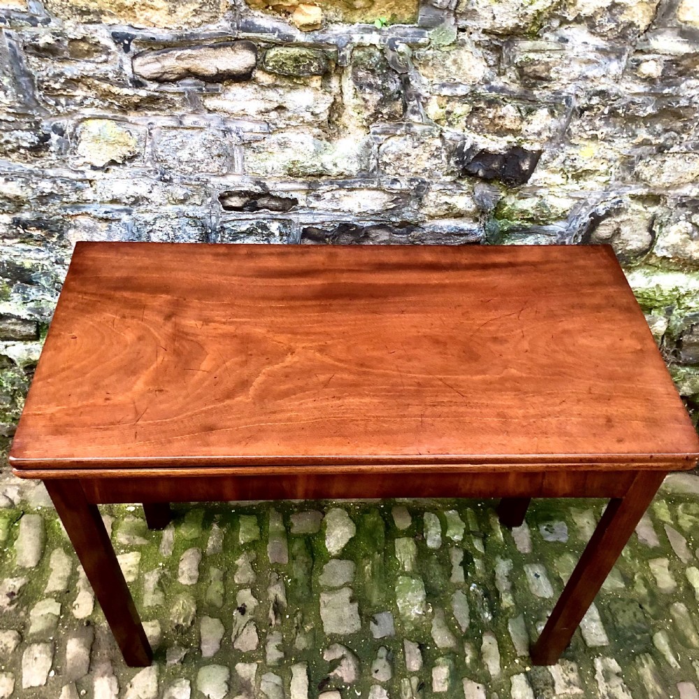 A George III mahogany card table View IX