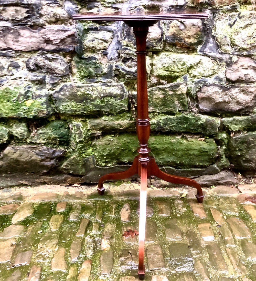 A late 19th-century mahogany wine table featuring a polished hexagonal top, turned central pedestal column, and three-legged tripod base. View II