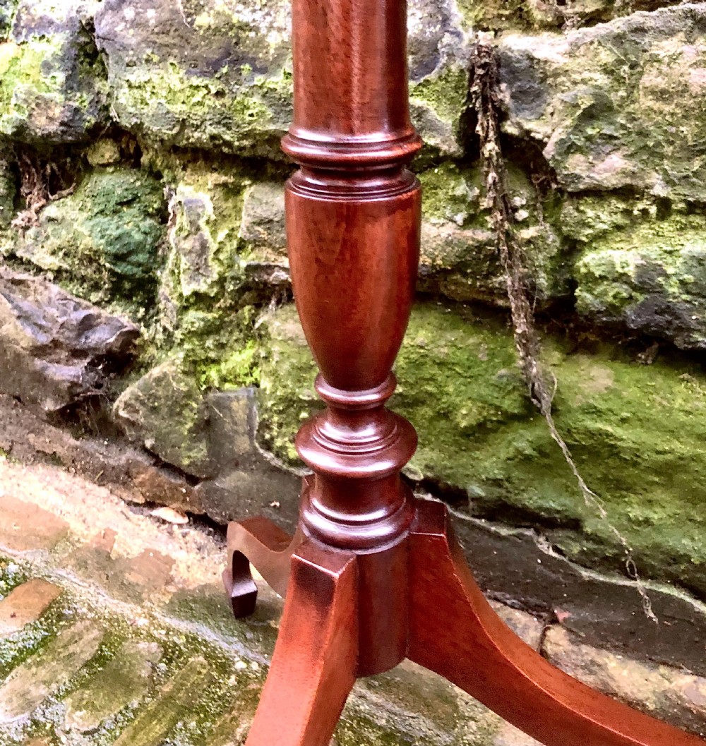 A late 19th-century mahogany wine table featuring a polished hexagonal top, turned central pedestal column, and three-legged tripod base. View III