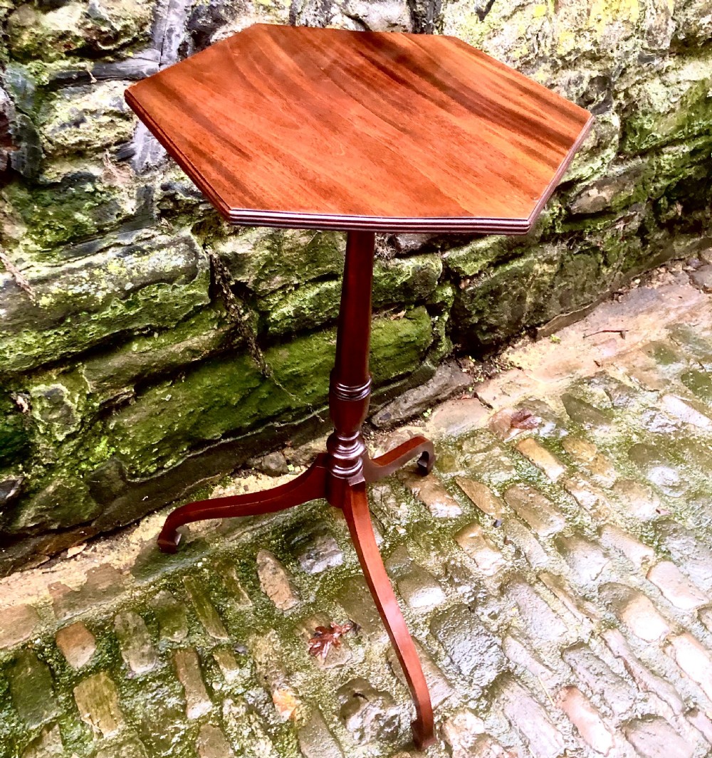 A late 19th-century mahogany wine table featuring a polished hexagonal top, turned central pedestal column, and three-legged tripod base. View V