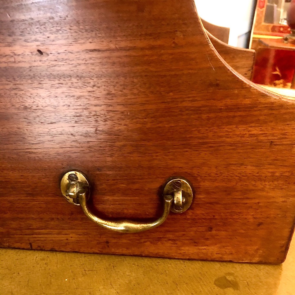 A George III mahogany book trough with two open divided compartments above a single drawer with two circular brass handles. View IV