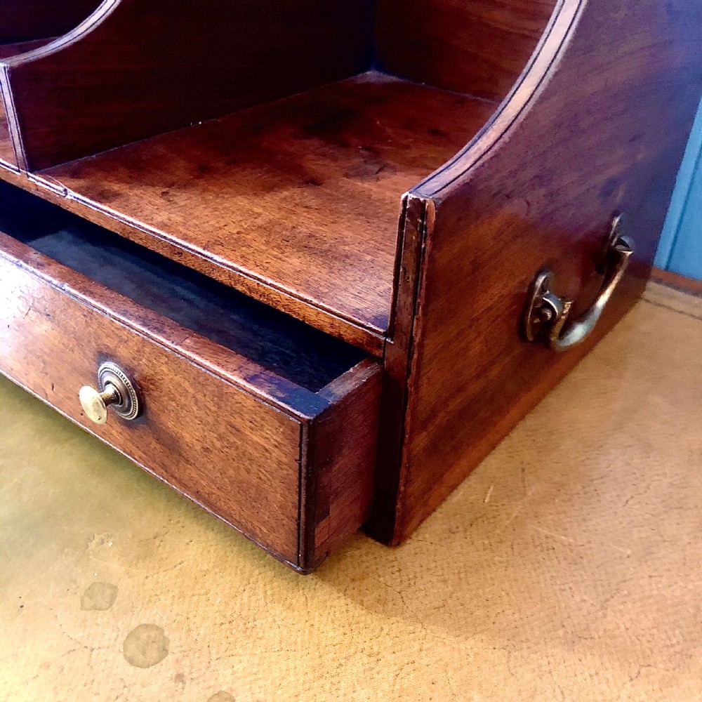 A George III mahogany book trough with two open divided compartments above a single drawer with two circular brass handles. View VI