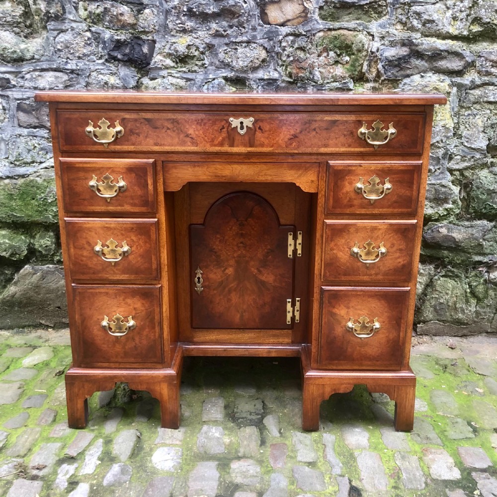 An early 20th century walnut kneehole desk