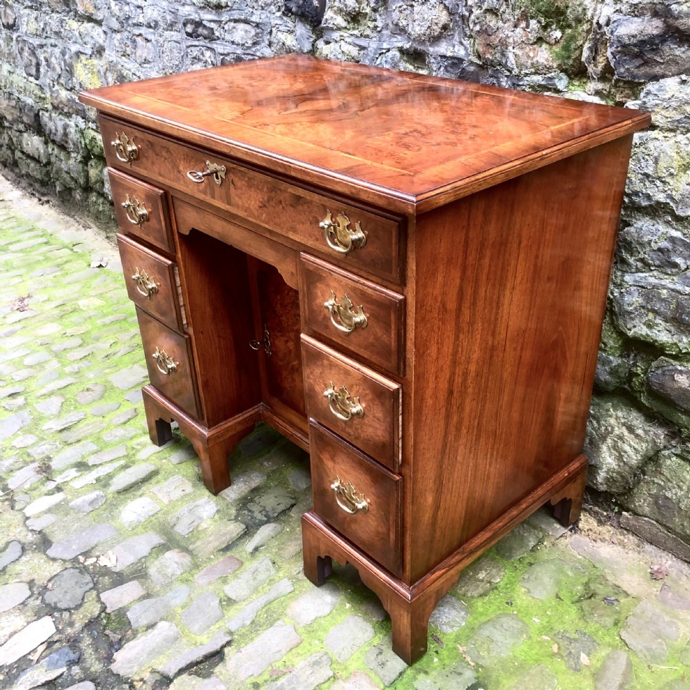 An early 20th century walnut kneehole desk View V