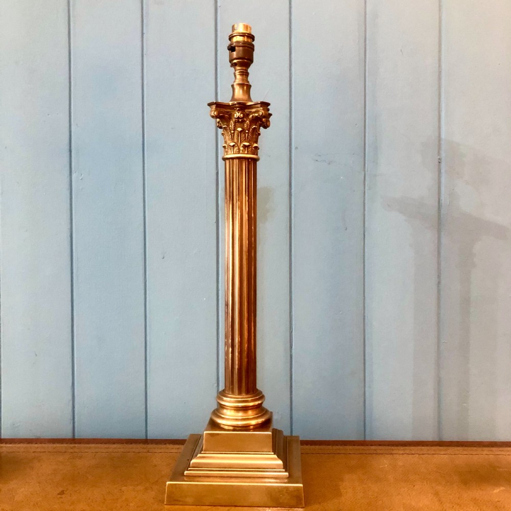 An early twentieth-century brass table lamp shaped as a fluted Corinthian column on a square stepped base. View VI