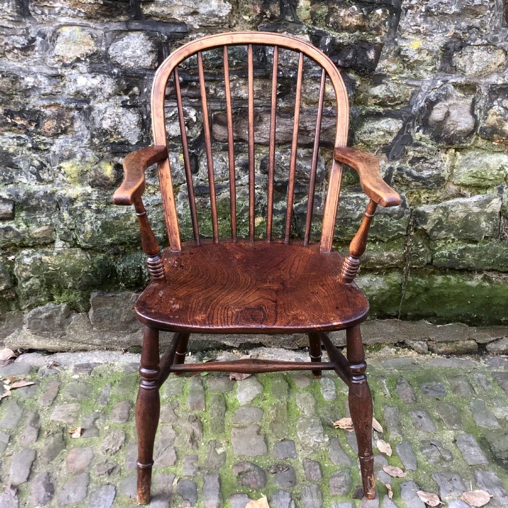 A mid 19th century ash and elm Windsor elbow chair