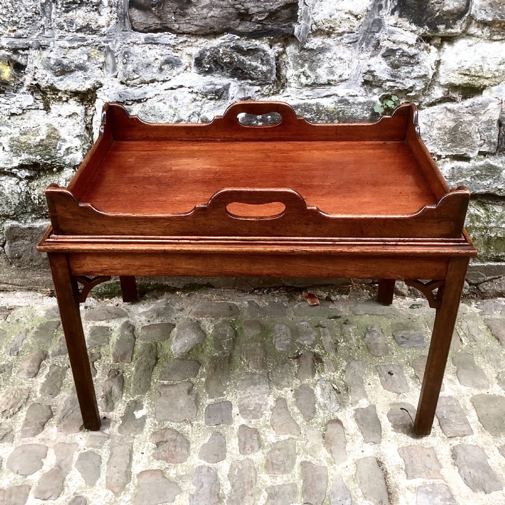 A small mahogany tray-top coffee table 