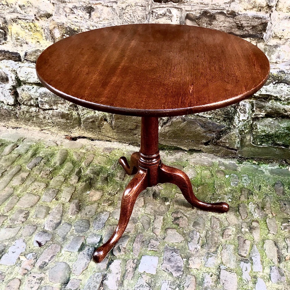A George III oak tripod pedestal tilt-top table