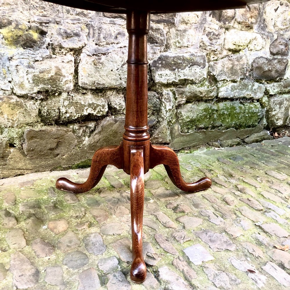 A George III oak tripod pedestal tilt-top table View III