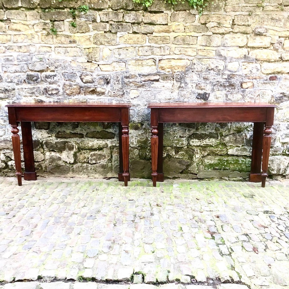 A pair of early Victorian mahogany console tables