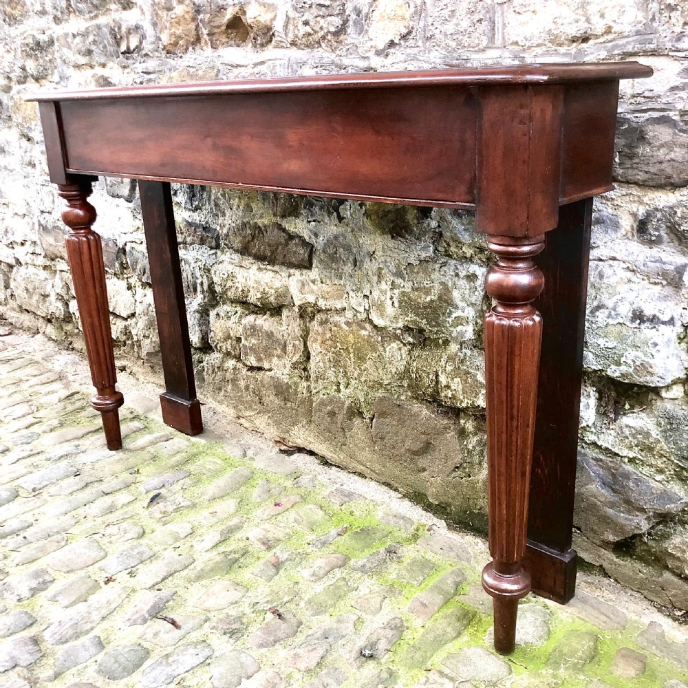 A pair of early Victorian mahogany console tables View IV