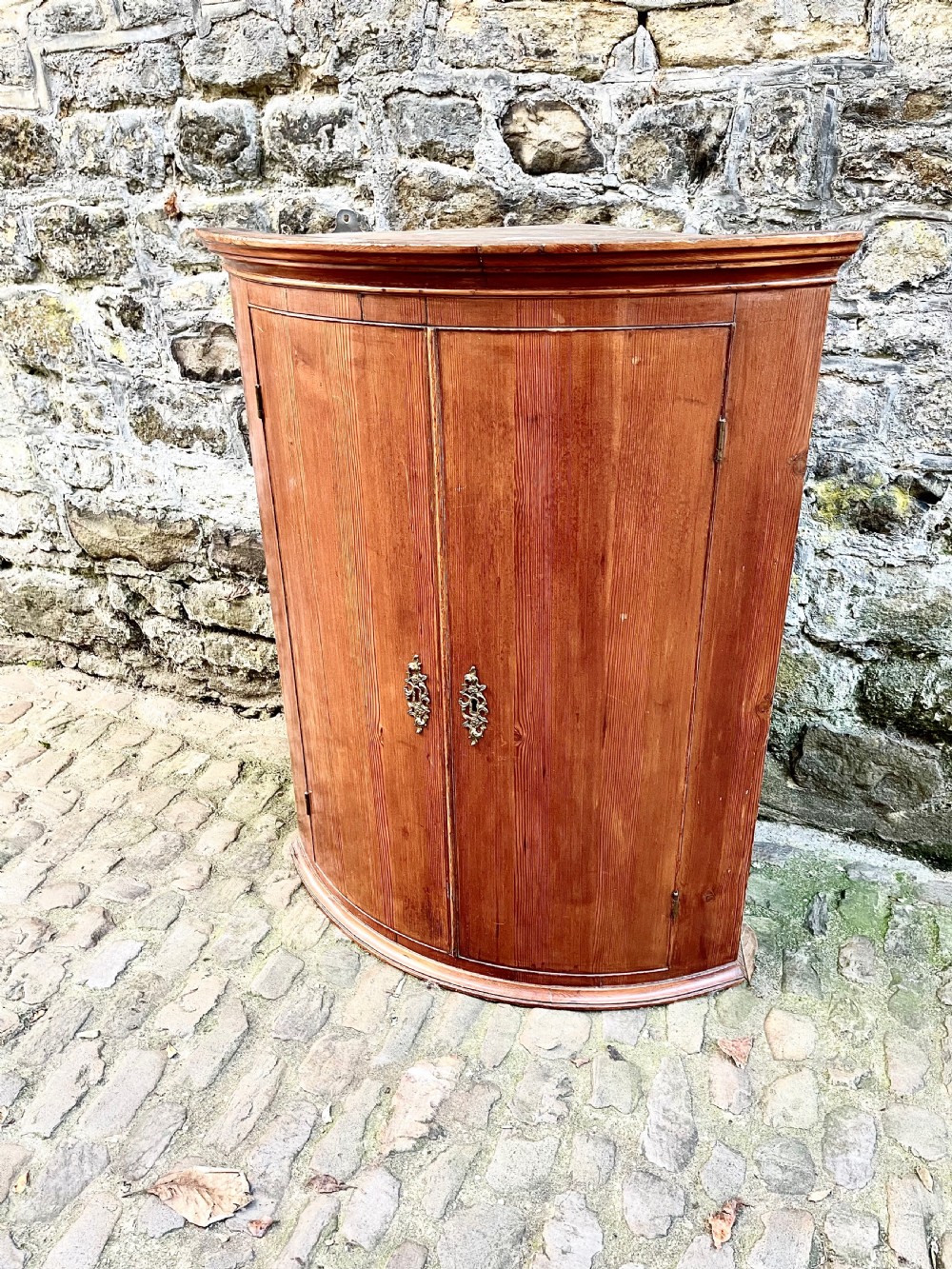 A George III pine bowfront corner cupboard  View II