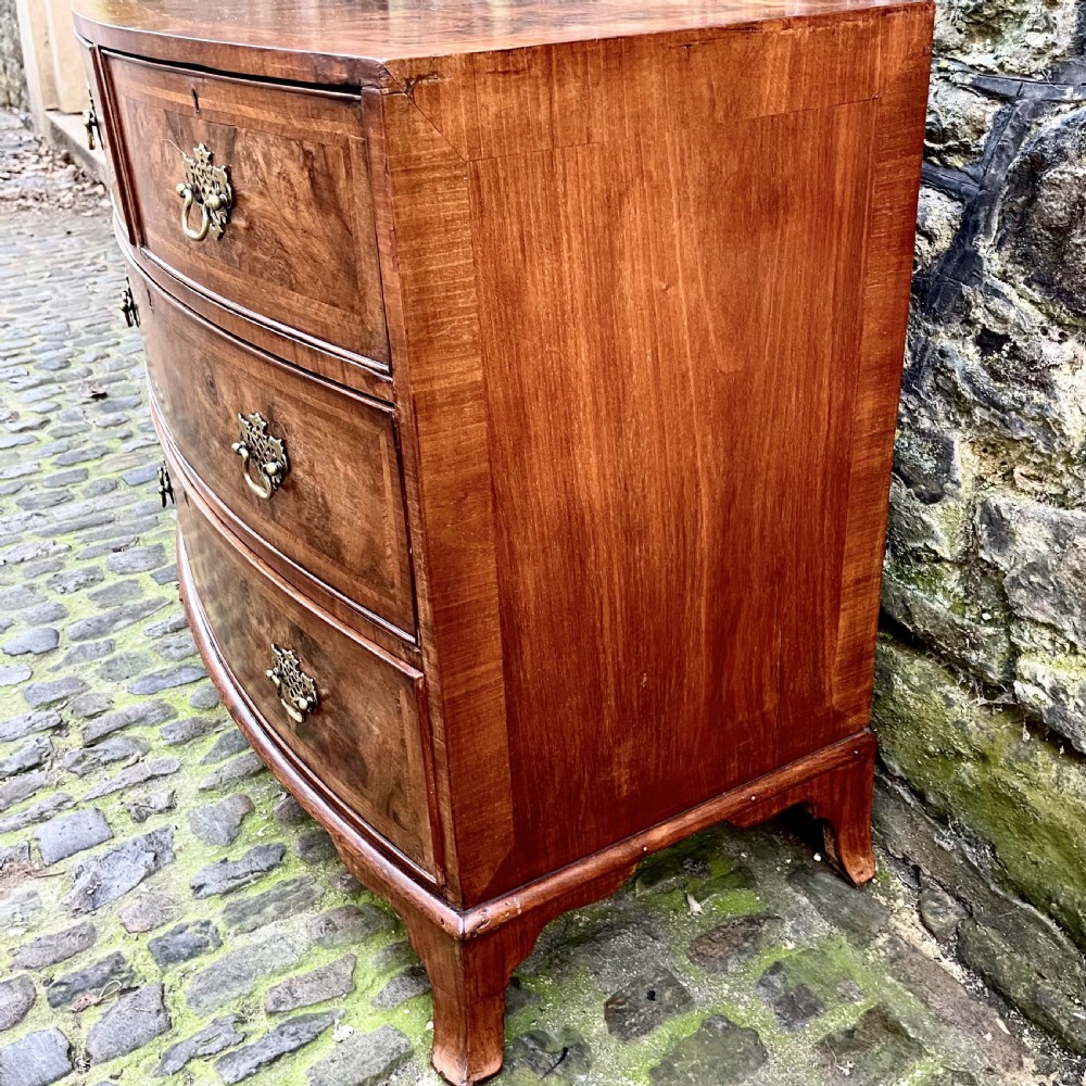 A Regency walnut bowfront chest of drawers View III