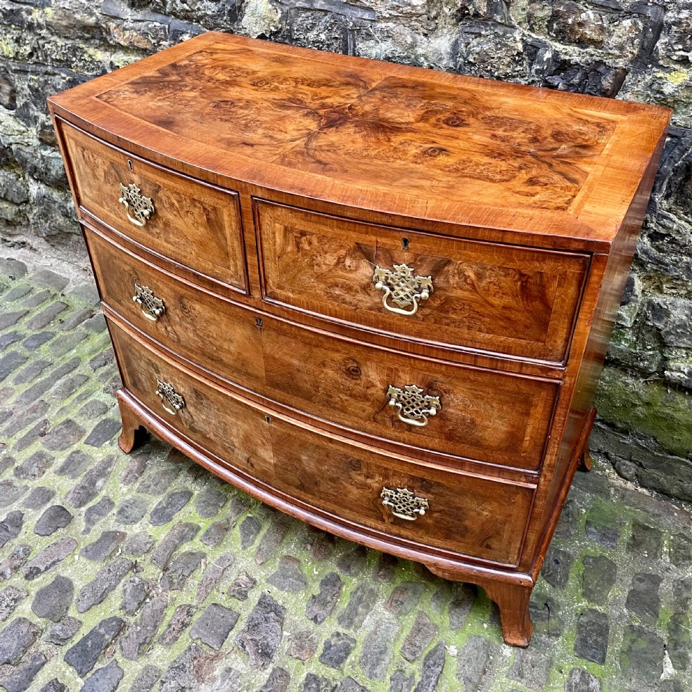 A Regency walnut bowfront chest of drawers View IV