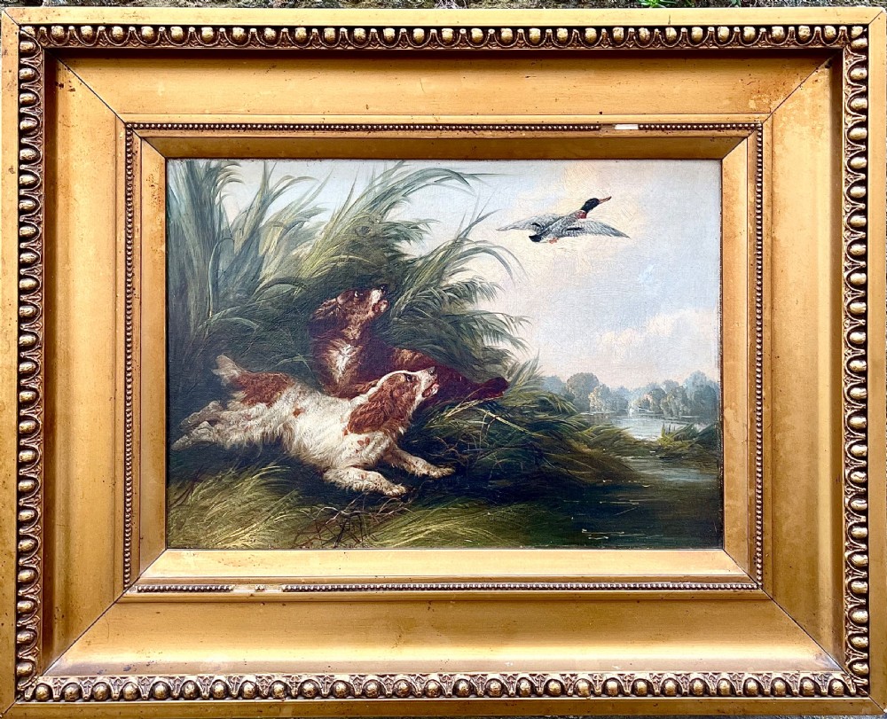 A late 19th century oil painting on canvas of spaniels hunting