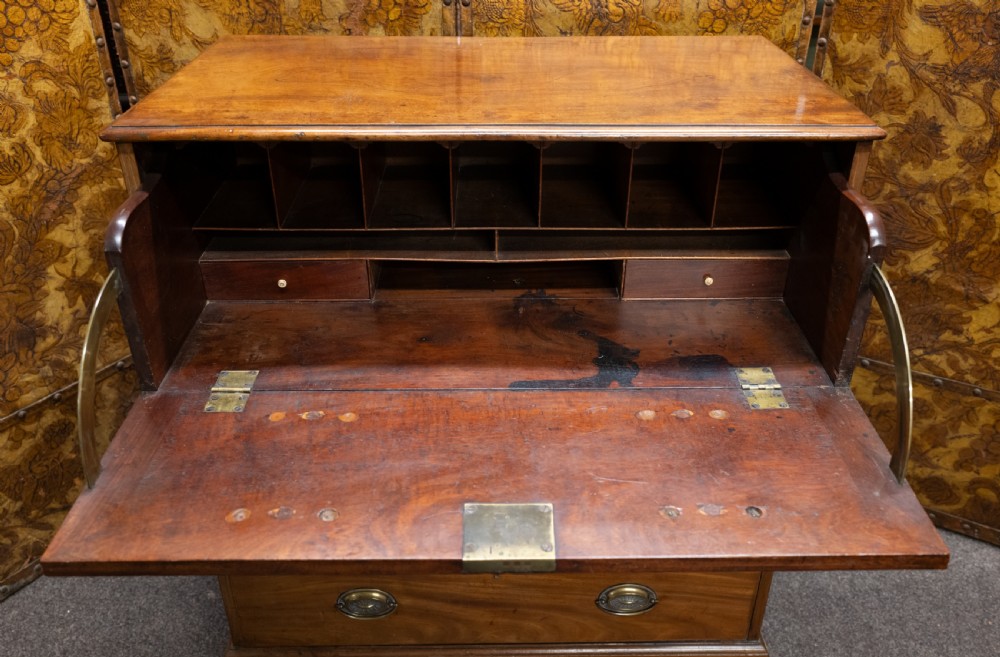 A George III mahogany secretaire chest featuring four graduated drawer fronts, oval brass backplate handles, keyhole escutcheons, and bracket feet. View III