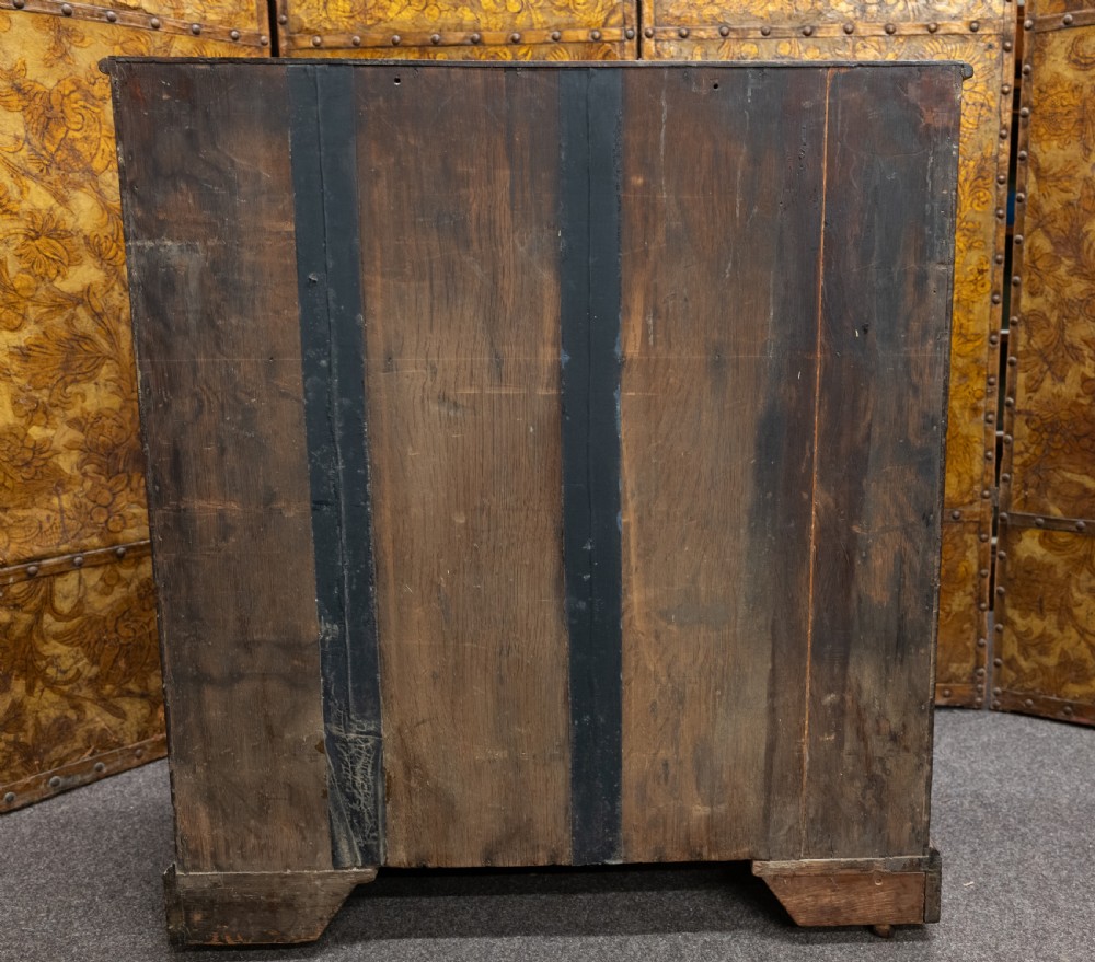 A George III mahogany secretaire chest featuring four graduated drawer fronts, oval brass backplate handles, keyhole escutcheons, and bracket feet. View V