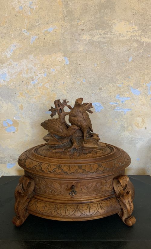 A CARVED BLACK FOREST CASKET
